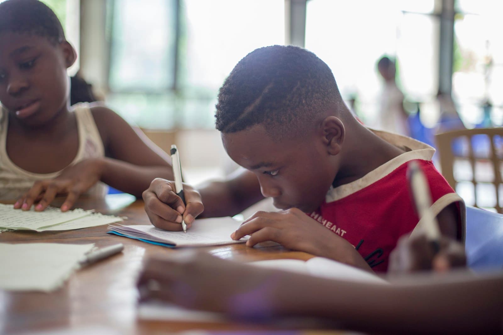 African child focused on a notebook, a symbol of education and the future in Cameroon